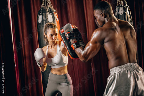 Professional boxing trainer analyze clients' goals, create tailored exercise plans, and lead one-on-one training sessions that include sandbag work. Instructing self-defense techniques in combination