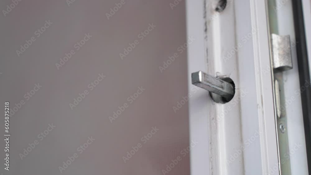 Assembly and disassembly of the lock and handle of a plastic door, close-up Assembly and disassembly of the lock and handle of a plastic door, close-up
