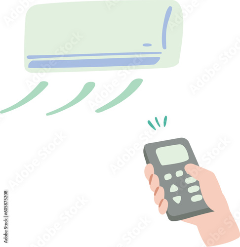 エアコンをリモコンで操作している