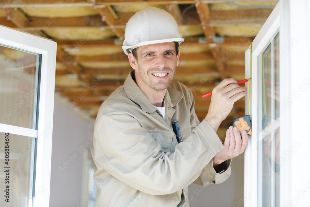 happy professional handyman fixing window handle at home happy professional handyman fixing window handle at home