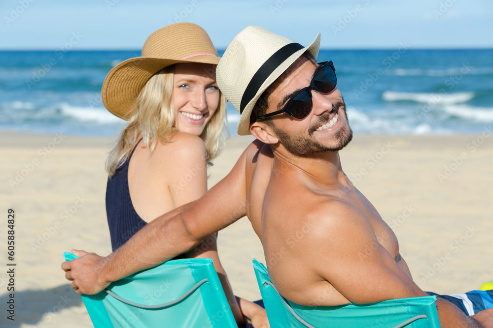 couple on the beach smiling for the picture