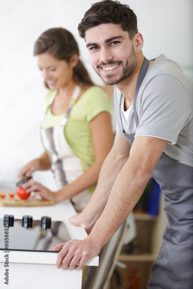 beautiful young couple cooking in kitchen at home beautiful young couple cooking in kitchen at home