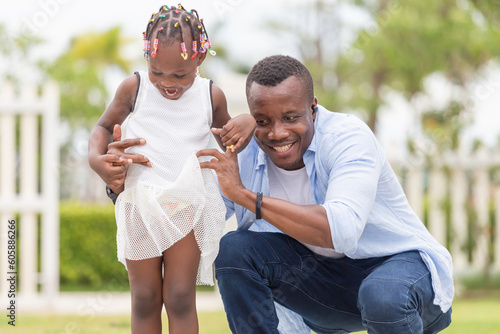 Cheerful African American father and daughter playing outdoor © JU.STOCKER