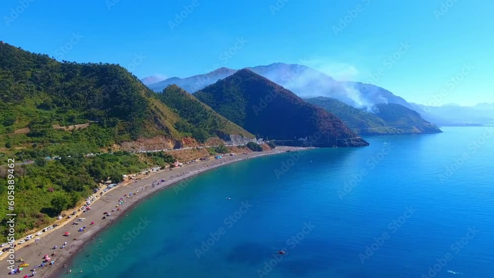very beautiful paradise beach under a hill with a transparent blue turquoise sea and mountain jijel algeria very beautiful paradise beach under a hill with a transparent blue turquoise sea and mountain jijel algeria