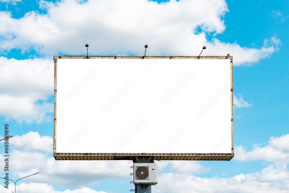 Blank billboard on blue sky for your advertising.An empty billboard,mockup against a blue cloudy sky, mockup.Summer hot day. Blank billboard on blue sky for your advertising.An empty billboard,mockup against a blue cloudy sky, mockup.Summer hot day.