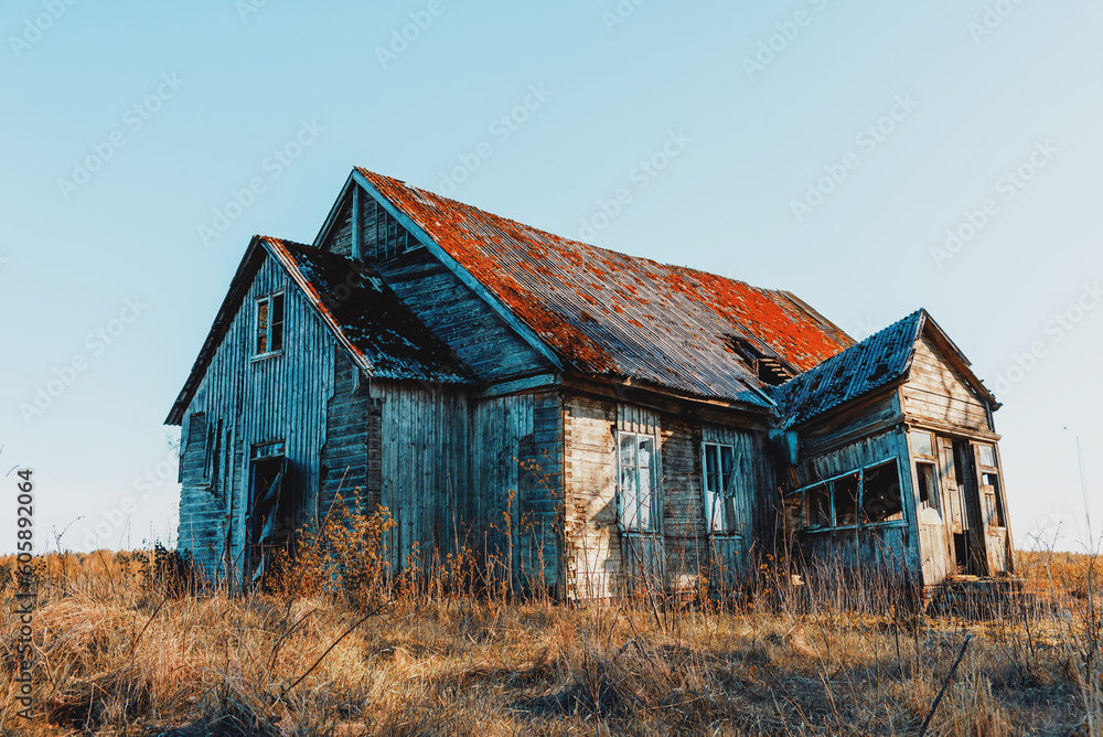 Abandoned 19th century house in a rural field at summer.Creepy summer evening.Toned. Abandoned 19th century house in a rural field at summer.Creepy summer evening.Toned.