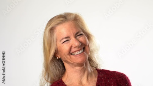 Closeup laughing out loud portrait of happy smiling beautiful 50s middle aged mature woman looking at camera, on white background. Anti age face beauty, skin and body care, wellness self care concept
