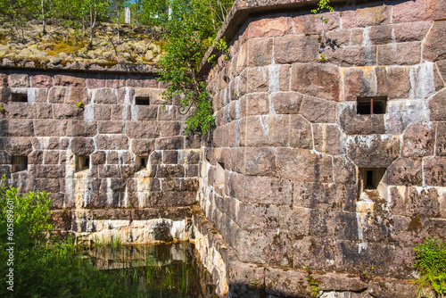 Old fortified wall in moat with water