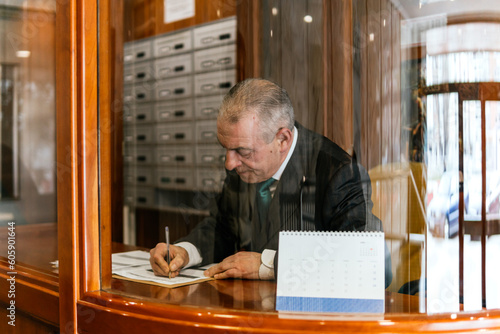 concierge typing in the portal of a building