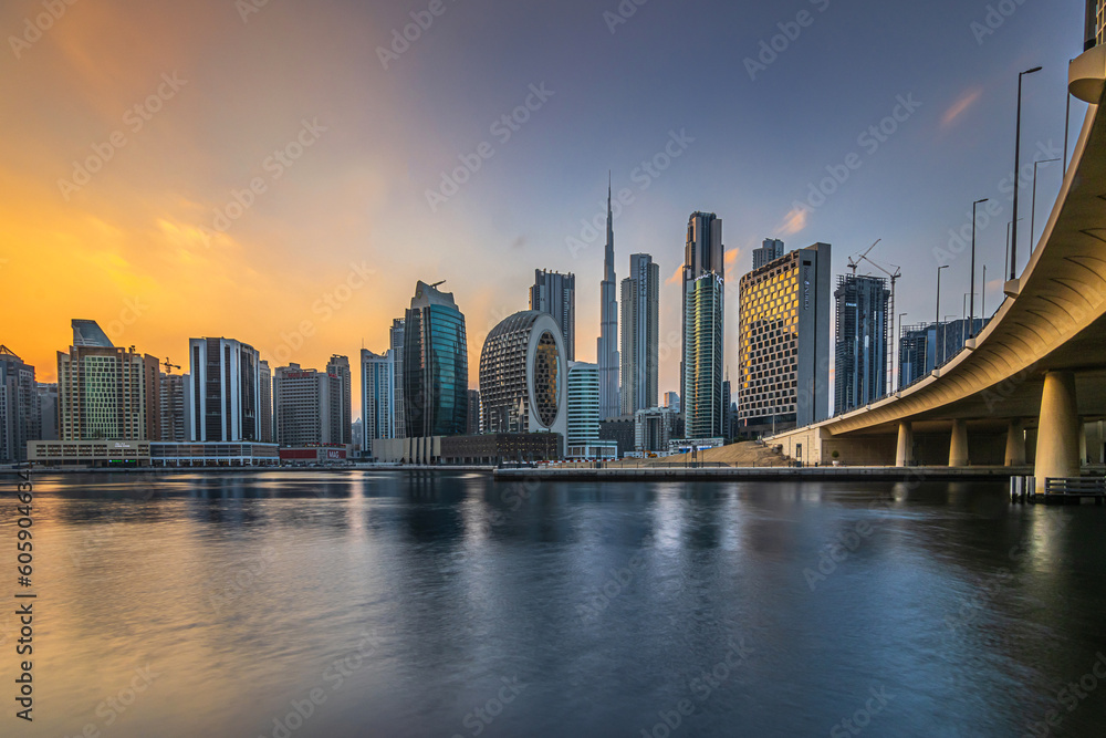 Evening mood with a view of the Dubai skyline at sunset.. High-rise buildings in the business and financial center of the Arab city in the Emirates. Skyscraper with the Burj Khalifa and reflection