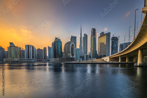 Evening mood with a view of the Dubai skyline at sunset.. High-rise buildings in the business and financial center of the Arab city in the Emirates. Skyscraper with the Burj Khalifa and reflection