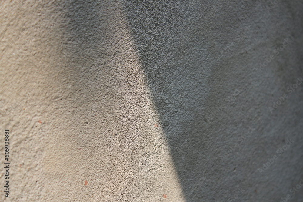 Fototapeta premium Cement and brick wall texture background, sun rays on the cement wall surface, smooth cement wall backdrop