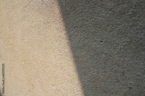 Cement and brick wall texture background, sun rays on the cement wall surface, smooth cement wall backdrop