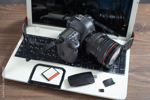 Modern DSLR camera and laptop computer.