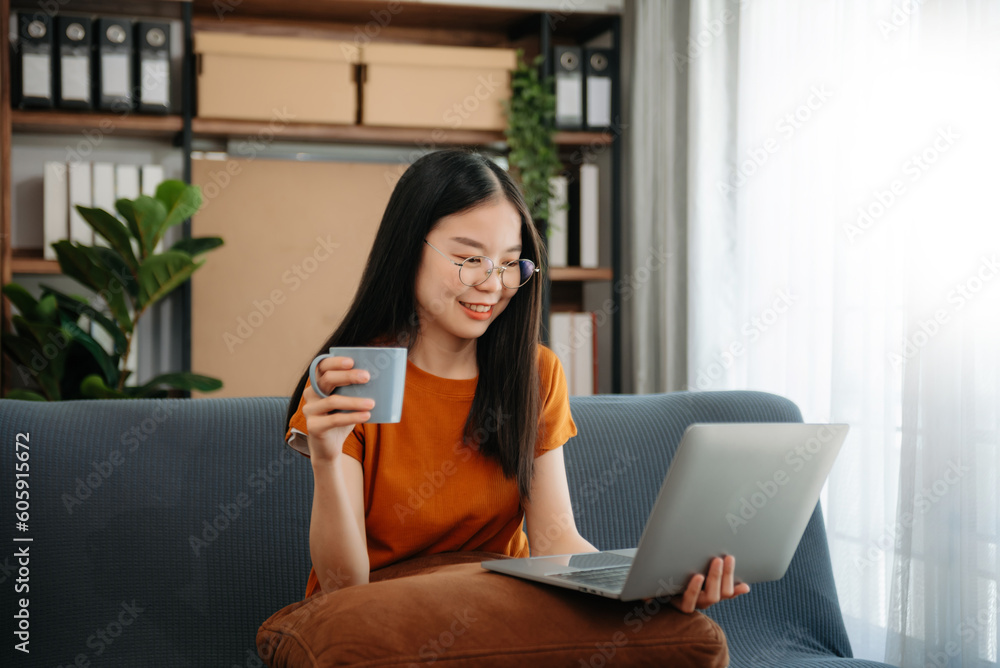 Asian woman using the smartphone and tablet on the sofa at home. Asian woman using the smartphone and tablet on the sofa at home.