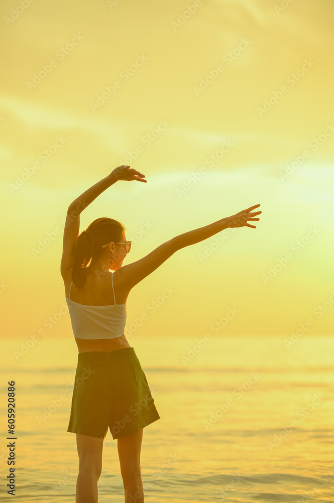 Fototapeta premium Happy family resting at beach in summer, Mother and baby boy feet at the sea foam at the sunlight water is moving