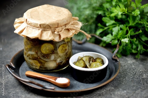 Pickled cucumber slices with dill and onion.