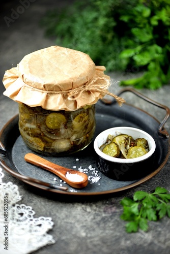 Pickled cucumber slices with dill and onion.