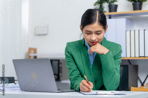 Young busy asian business woman manager, lawyer doing bookkeeping audit graph documents checking Bank Reconciliation, Base Stock, Last Invoice Price, Freight, Drop Product or Drop Section Decisions
