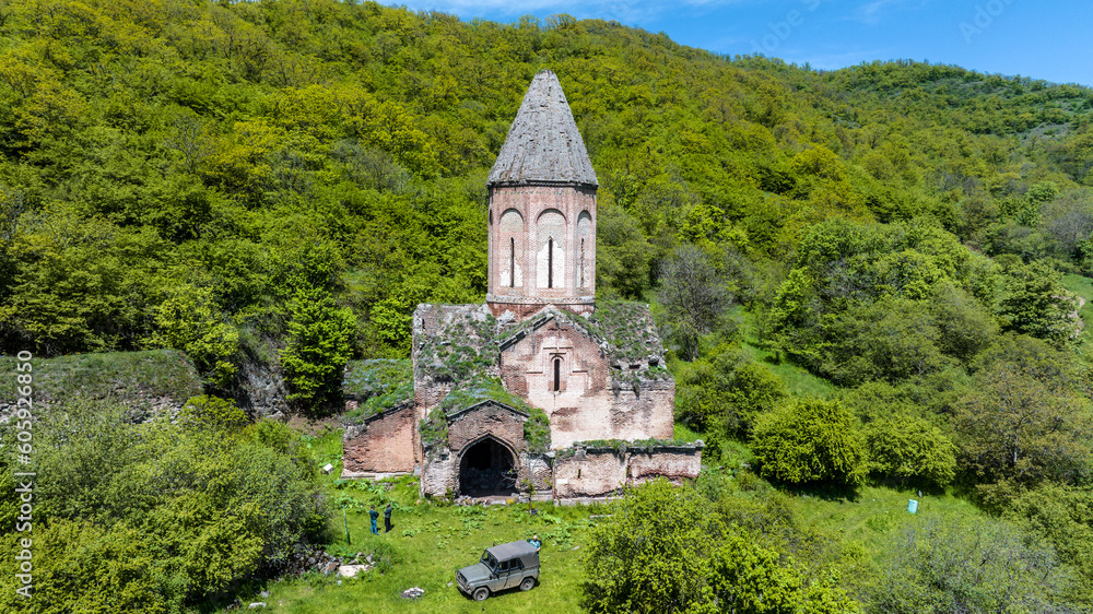 the ancient church hid in the forest in the gorge of the mountains of Armenia taken from a drone