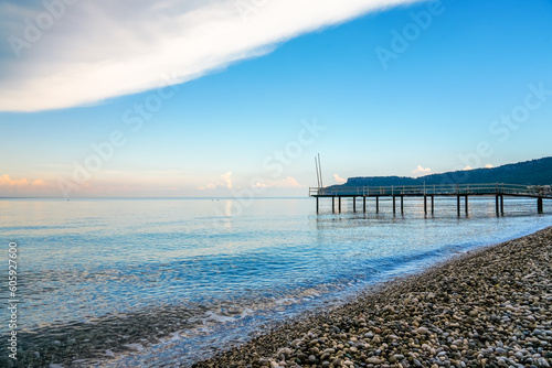 Mediterranean Sea near Kemer. Landscape in Turkey. Nature on the beach with a jetty in the background. 