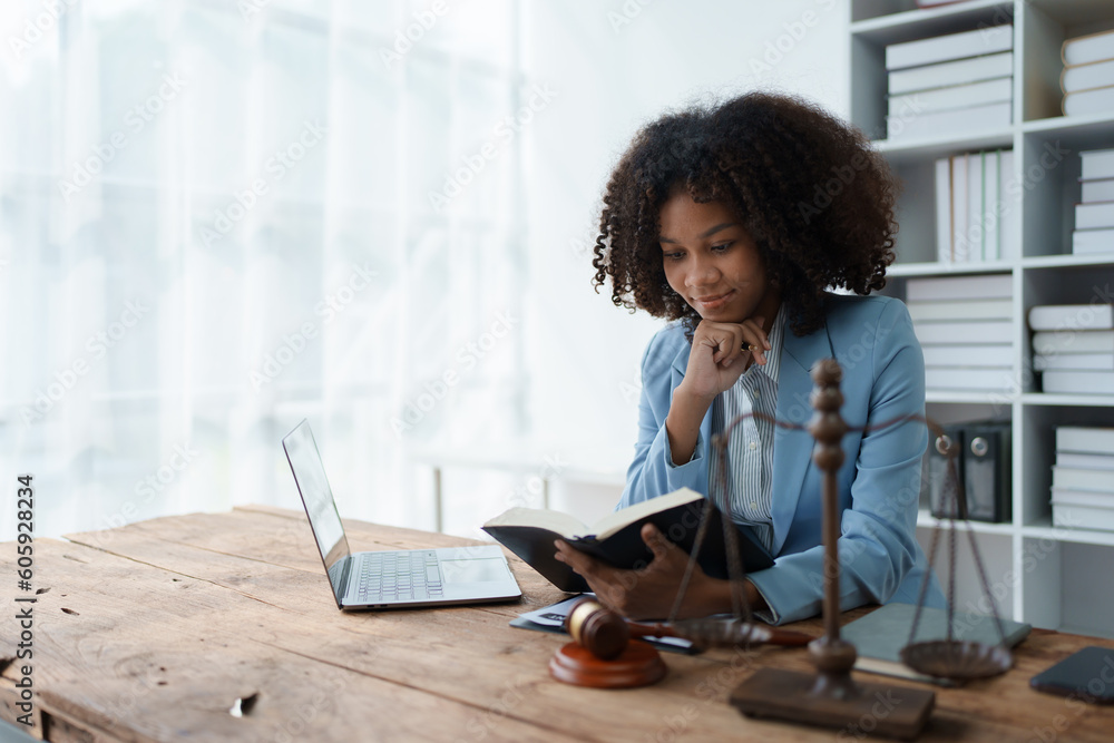 A young women African American lawyer lawsuit studying cases for clients in a law firm to fight against their parties in the courts. law and attorney concepts. A young women African American lawyer lawsuit studying cases for clients in a law firm to fight against their parties in the courts. law and attorney concepts.