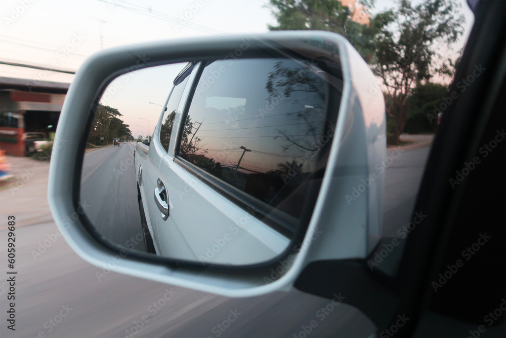 Landscape in the sideview mirror of a car , on road countryside. side rear-view mirror car reflection on countryside road