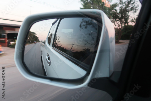 Landscape in the sideview mirror of a car , on road countryside. side rear-view mirror car reflection on countryside road