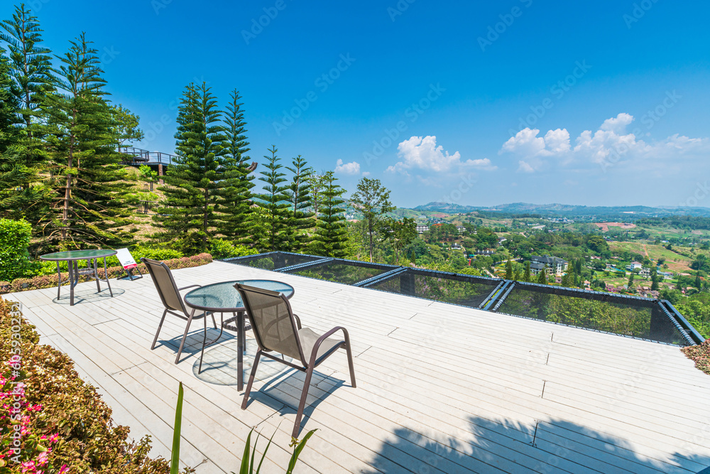 Sitting table and Panoramic high view mountain range on Nature Trail in Khao Kho National Park in Phetchabun,Thailand, blue sky background texture with white clouds