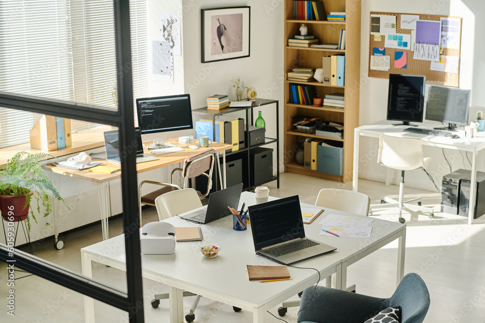 High angle view of modern IT office with workplaces of programmers
