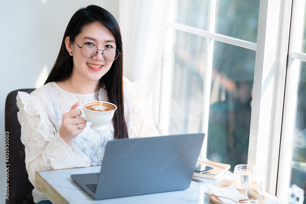 Happy of asian freelance people businessfemale hold a coffee cup mug casual working with laptop computer with Notebook and smartphone in coffee shop,Business Lifestyle communication concept Happy of asian freelance people businessfemale hold a coffee cup mug casual working with laptop computer with Notebook and smartphone in coffee shop,Business Lifestyle communication concept