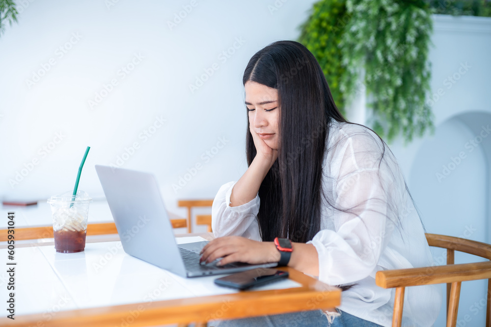 asian freelance people business female wearing smartwatch talking making using casual working with laptop computer for browsing internet, chatting and blogging and smartphone,notebook in coffee shop. asian freelance people business female wearing smartwatch talking making using casual working with laptop computer for browsing internet, chatting and blogging and smartphone,notebook in coffee shop.
