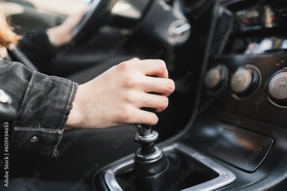 person holding a manual shift knob in the vehicle person holding a manual shift knob in the vehicle