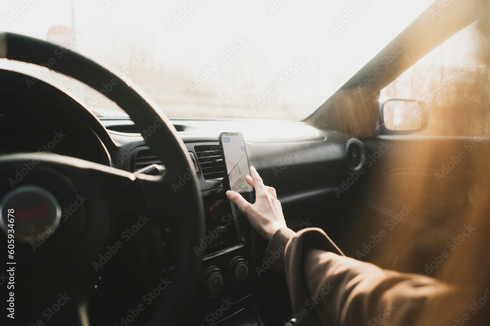 Naklejka premium car driver touch smartphone using navigator