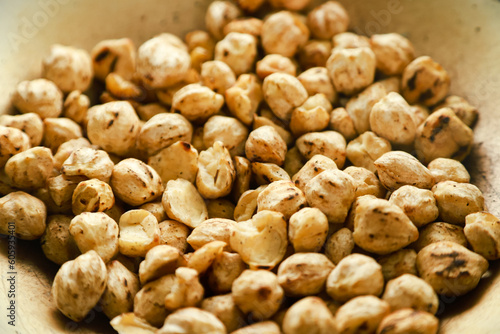 Kemiri or candlenut are fried in a frying pan before finally being mashed and the oil is squeezed out