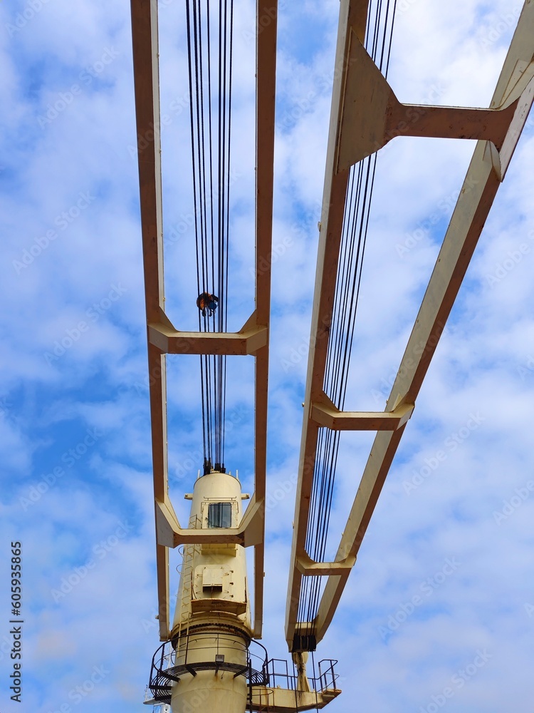 Crane jib with ship crew on it during the wire lubrication progress