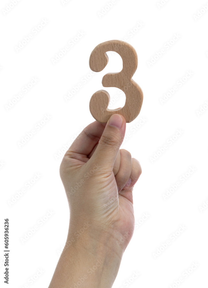 Hand holding wooden number 3 Hand holding wooden number 3
