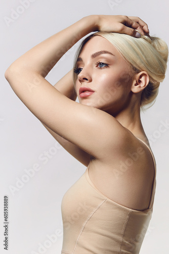 Portrait of a young blonde woman with natural makeup and natural styling. Advertising of natural cosmetics. Beauty salon advertisement. Care cosmetics, face and body skin care.
