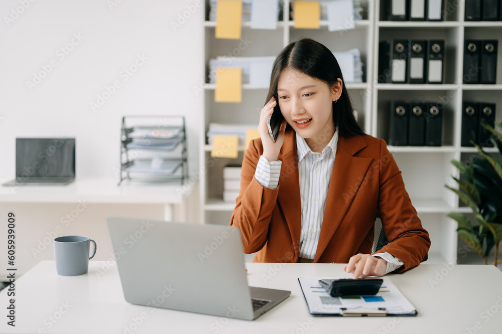 Happy asian business woman have the joy of talking on the smartphone, tablet and laptopon the office . Happy asian business woman have the joy of talking on the smartphone, tablet and laptopon the office .