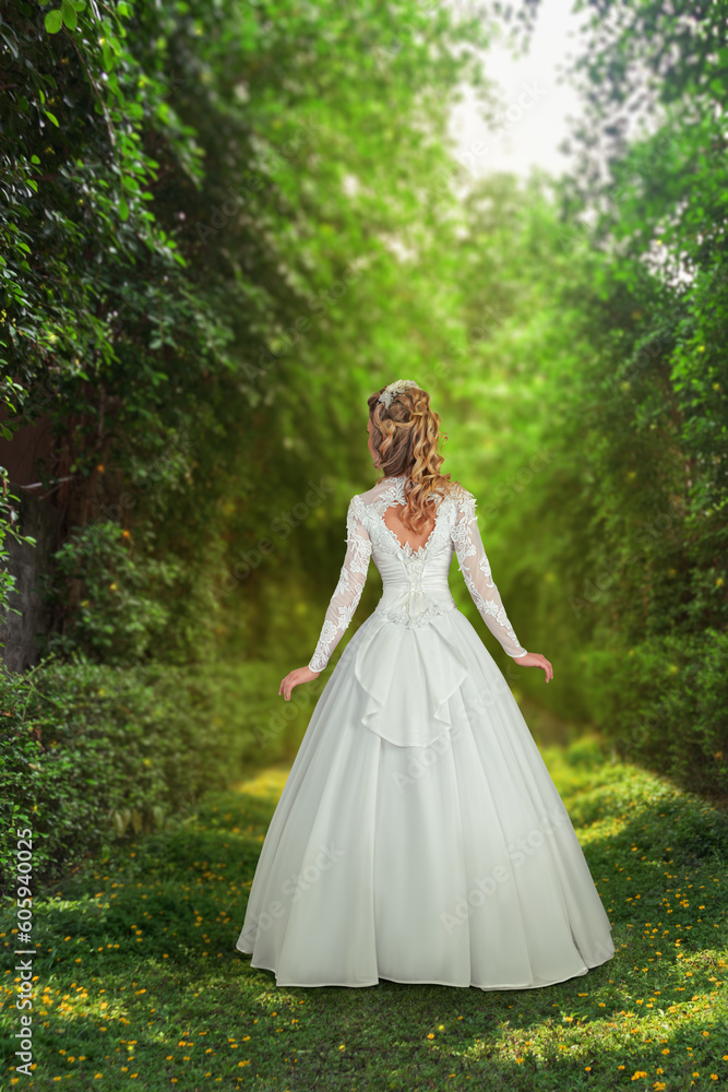 Woman in wedding dress standing in front of sunny forest