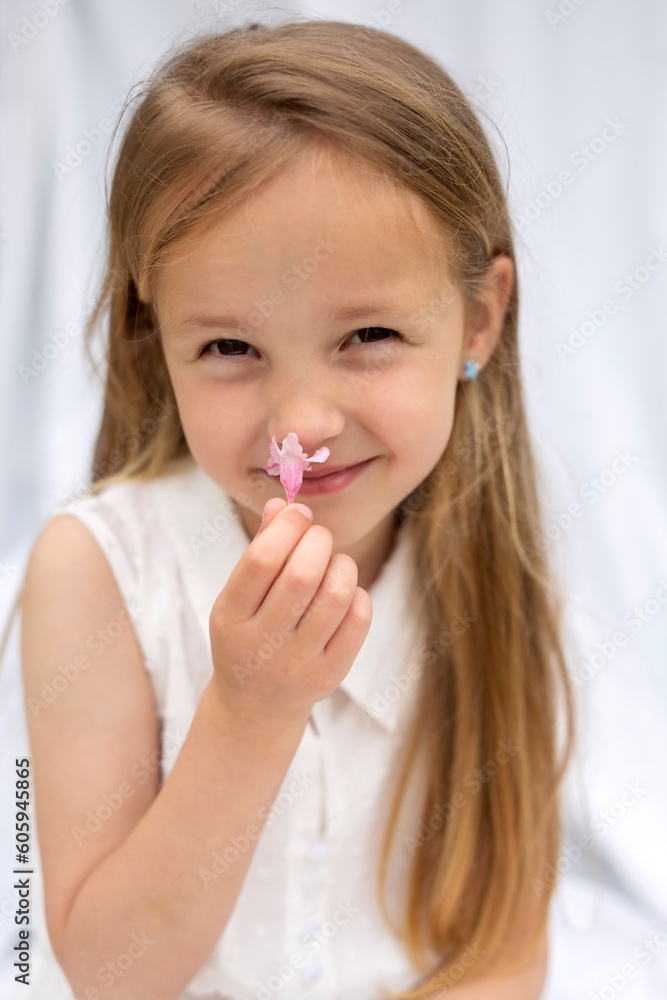 Portrait of a girl sniffing a flower Portrait of a girl sniffing a flower