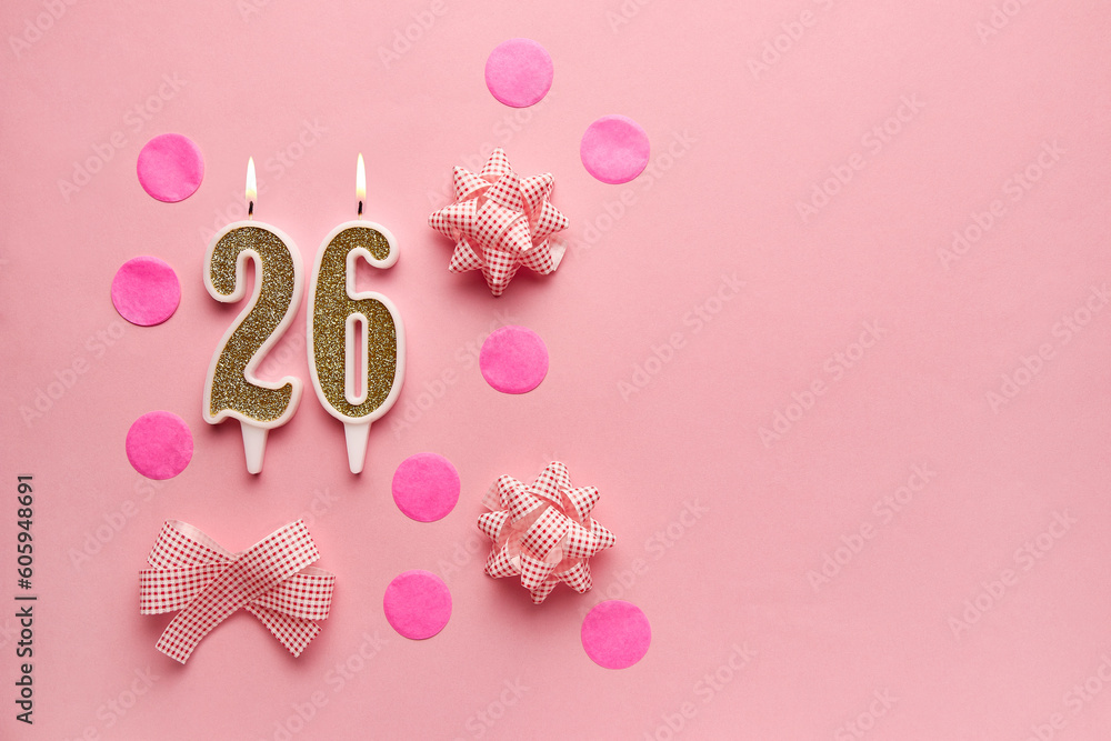 Number 26 on pastel pink background with festive decor. Happy birthday candles. The concept of celebrating a birthday, anniversary, important date, holiday. Copy space. Banner