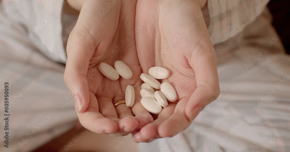 Close-up of hands with pills. Lots of pills ready to use. Maintenance of the body with medicines. Treatment of a person's mental health Close-up of hands with pills. Lots of pills ready to use. Maintenance of the body with medicines. Treatment of a person's mental health