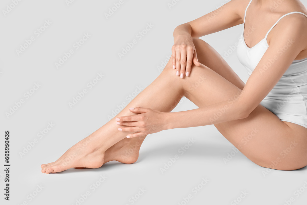 Woman with beautiful smooth legs on white background, closeup Woman with beautiful smooth legs on white background, closeup