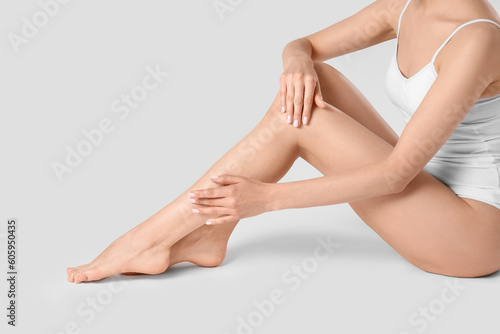 Woman with beautiful smooth legs on white background, closeup