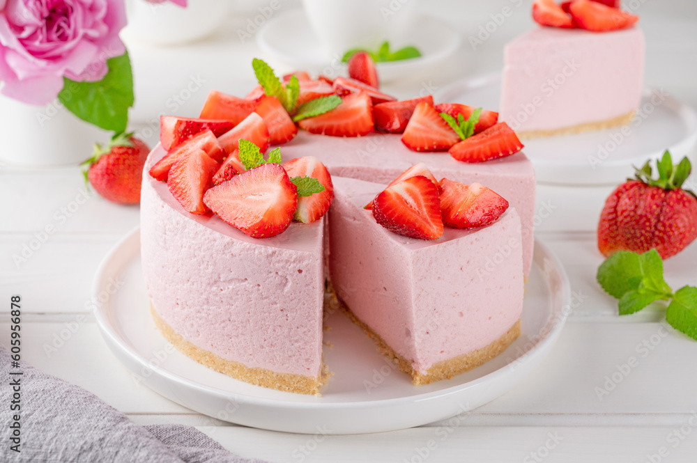 No bake cheesecake with fresh strawberries on a white wooden background. Summer dessert. Selective focus. Copy space. No bake cheesecake with fresh strawberries on a white wooden background. Summer dessert. Selective focus. Copy space.
