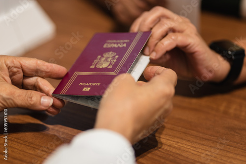Billede på lærred senior woman handing over passport at airport
