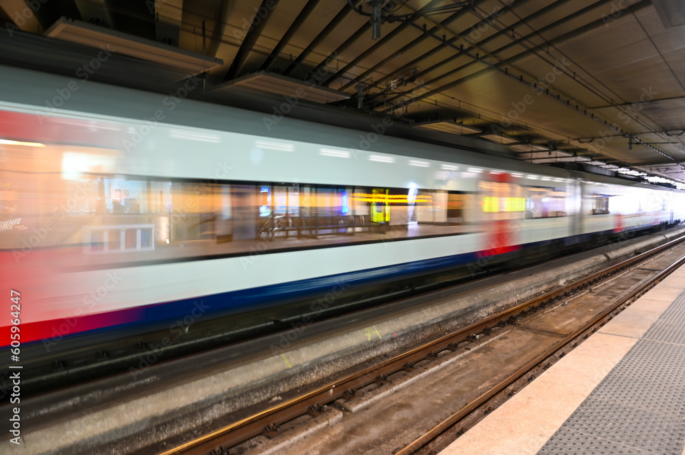 Blurred train. A passenger train passes fast through the railway station. Blurred train. A passenger train passes fast through the railway station.
