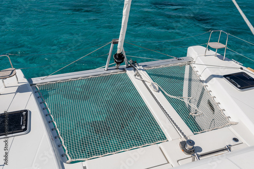 From above of net on deck of modern catamaran sailing in sea on sunny day in summer © Pintau Studio