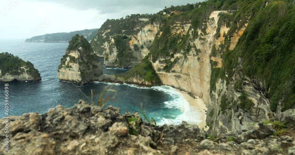 Handheld Shot of the Cliffs on Nusa Penida in Bali, Indonesia Overlooking the Blue Sea with Waves on the Diamond Beach and Cliffs on a Beautiful Morning Handheld Shot of the Cliffs on Nusa Penida in Bali, Indonesia Overlooking the Blue Sea with Waves on the Diamond Beach and Cliffs on a Beautiful Morning